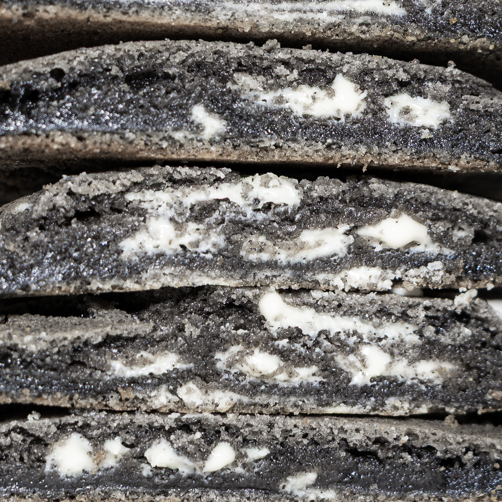 Cross section of black sesame cookies showing interior chewiness and white chocolate